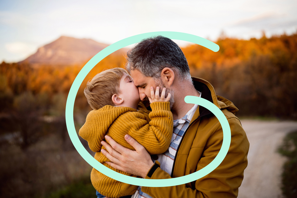 child hugging father outdoors